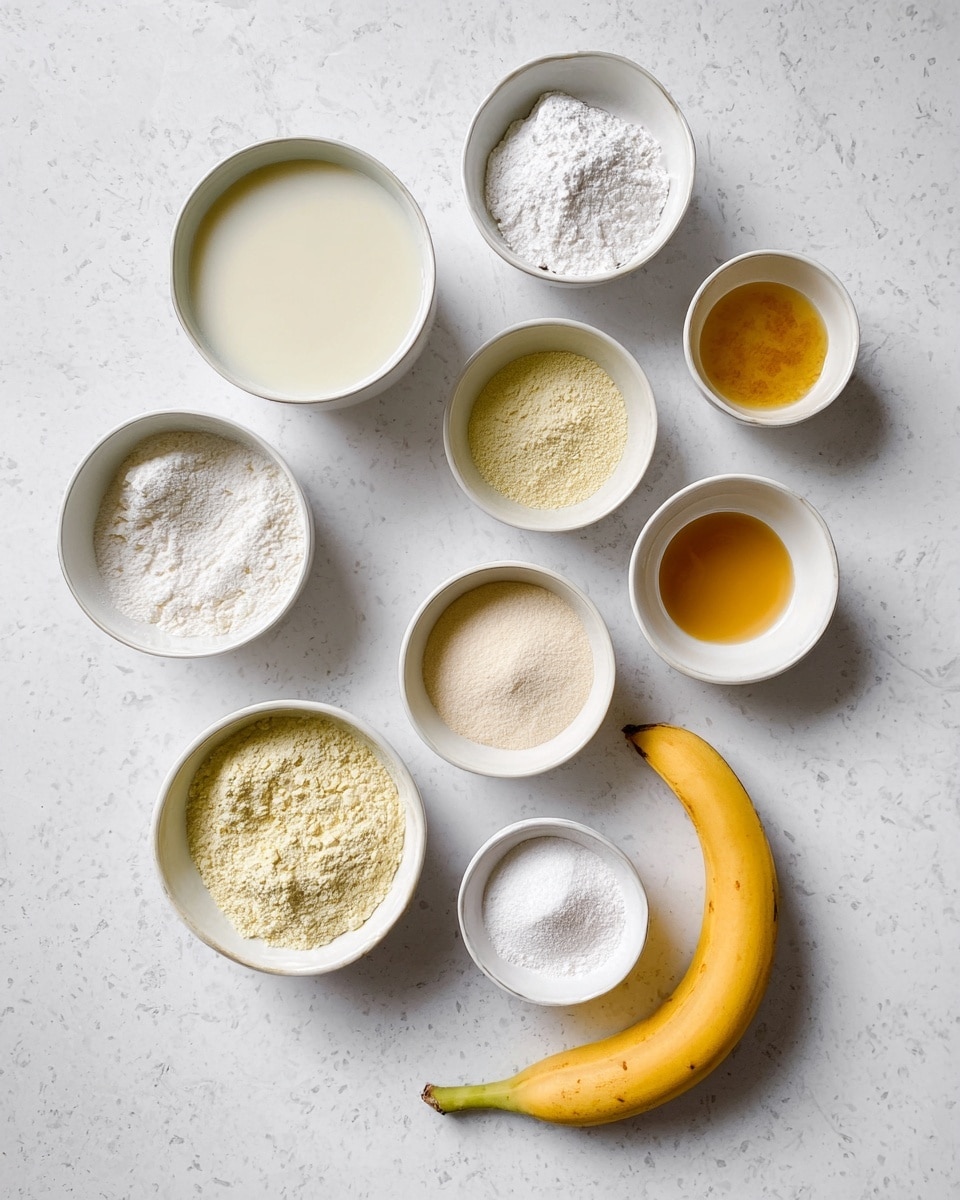 The image shows nine small white bowls arranged on a white marbled surface, each holding different ingredients including a creamy liquid, light yellow powder, white powder, and golden oil among others, with a ripe yellow banana placed at the bottom right side. The bowls are laid out in a slightly scattered manner with a mix of powders and liquids that contrast softly against the white marbled background. photo taken with an iphone --ar 4:5 --v 7