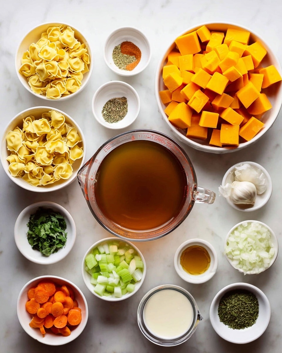 A white pot with handles on both sides is filled with a smooth orange-yellow soup with a creamy texture. On top, there is a single layer of small, uncooked tortellini pasta, pale yellow in color, arranged mostly in the center, some floating slightly above the soup's surface. The pot sits on a white marbled surface that gives a clean and bright look. Photo taken with an iphone --ar 4:5 --v 7