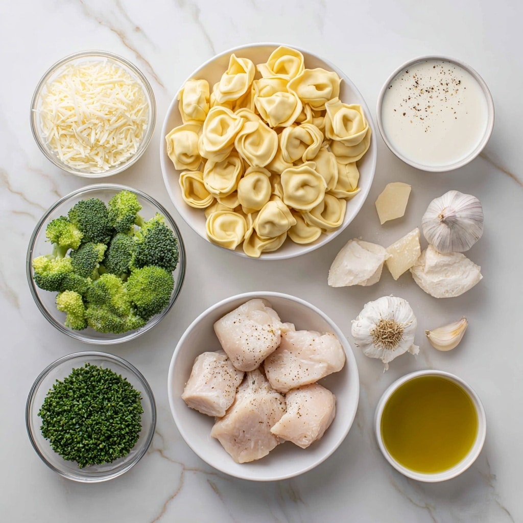 A white plate holds a creamy pasta dish with three layers: the base is a rich, light yellow creamy sauce that pools around the food, scattered green broccoli florets add bright color and texture evenly across the plate, and on top, golden-brown pan-fried pieces with a slightly crispy surface are mixed with soft tortellini pasta showing off smooth, folded shapes. Small sprinkles of grated cheese and finely chopped herbs cover the dish, giving a fresh and savory look. The plate sits on a white marbled surface. photo taken with an iphone --ar 4:5 --v 7