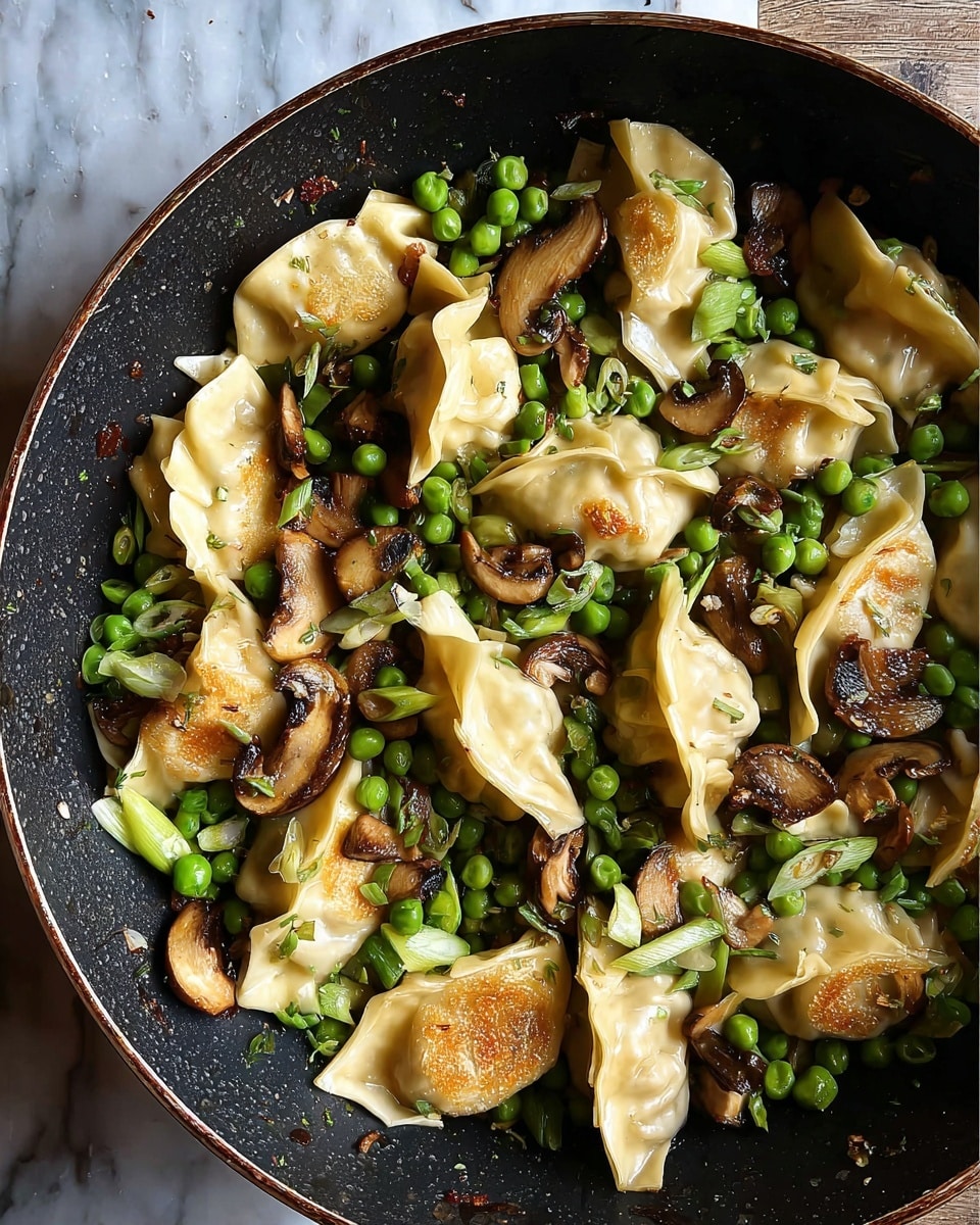 A white bowl holds several golden brown dumplings with a shiny, slightly oily surface, each sprinkled with black sesame seeds and red chili flakes. Among the dumplings are bright green peas and pieces of green onion, adding fresh color and texture. There are also sautéed brown mushroom slices scattered throughout, showing a soft, cooked texture. The whole dish sits on a white marbled surface with a visible silver spoon partially inside the bowl. photo taken with an iphone --ar 4:5 --v 7