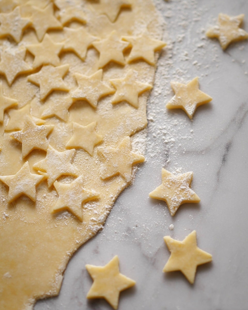 A white marbled surface holds a flat, rolled-out dough layer in light beige color with a slightly rough texture. On the left side, many star shapes have been cut out from the dough but remain attached by thin strips of dough, while a few stars are separated and placed on the marbled surface around the main dough. The dough is dusted lightly with white flour, adding a soft powdery texture. The stars have five points and show smooth edges, giving a neat and clean visual contrast to the flat dough. Photo taken with an iphone --ar 4:5 --v 7