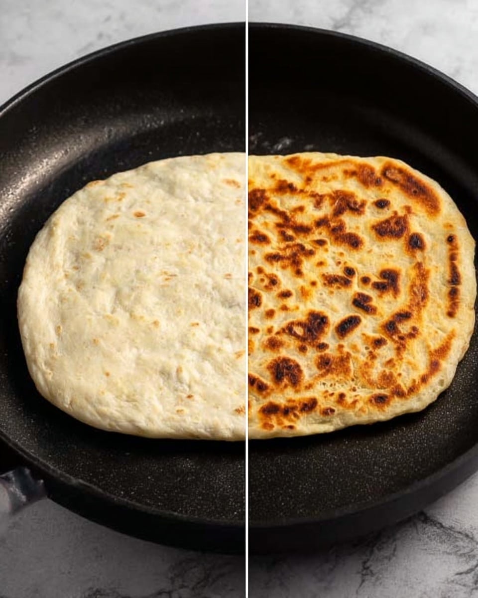The image shows two stages of cooking a flatbread in a black pan. On the left side, there is a pale, uncooked, slightly thick round dough with a soft texture and some small dark spots. On the right side, the same flatbread is golden brown with lots of small darker spots, showing it is cooked and has a crispy surface. Both flatbreads sit directly in the center of the black pan, which has a smooth matte texture. The background has been changed to a white marbled texture. Photo taken with an iphone --ar 4:5 --v 7