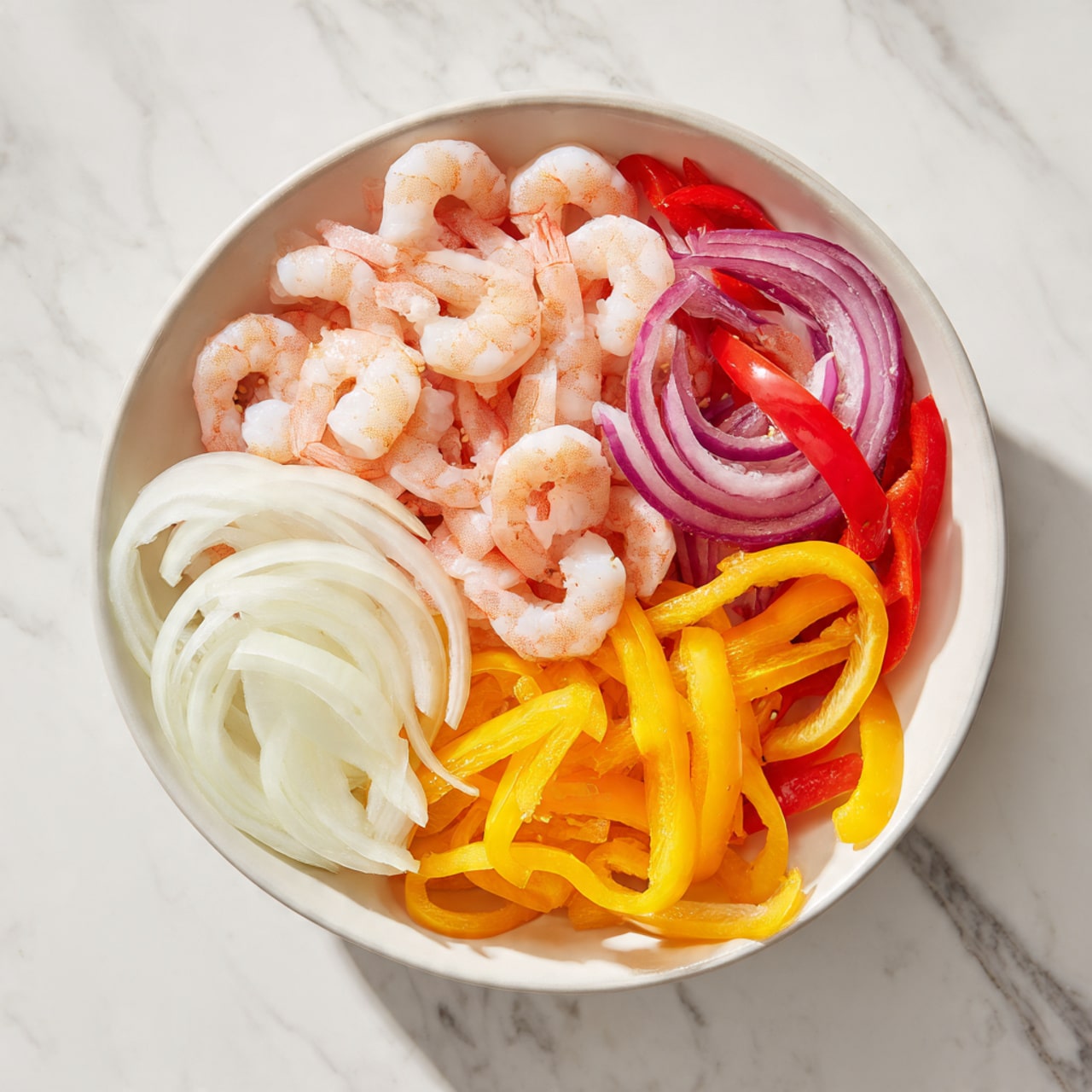 A white bowl filled with three layers of food: the bottom layer has white and yellow sliced onions, the middle layer contains bright yellow and orange sliced bell peppers, and the top layer is covered with a pile of small, light pink shrimp. The bowl is placed on a white marbled surface. photo taken with an iphone --ar 4:5 --v 7