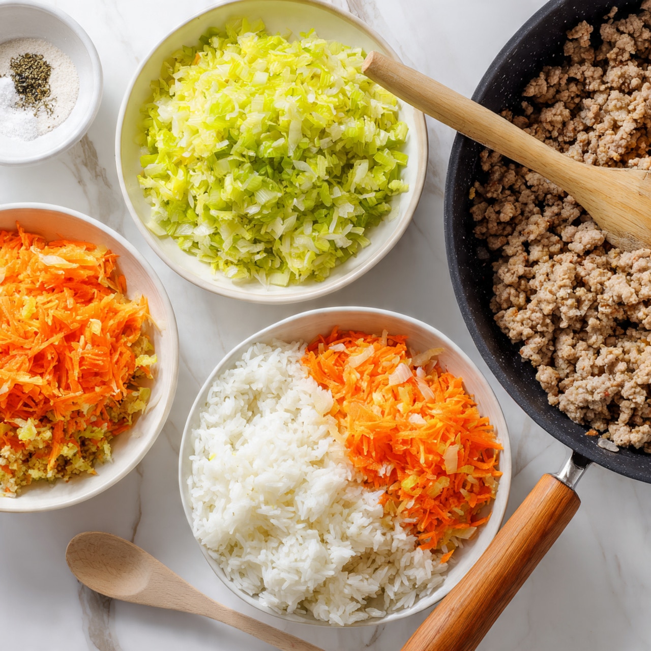 A white bowl filled with four ingredients placed in separate sections: fluffy white cooked rice on the right bottom, light green finely chopped celery on the right top, bright orange shredded carrots on the bottom left, and a portion of raw ground meat with white salt and black pepper on top on the top left; next to it, a white bowl with a mixed light beige and orange mixture of these ingredients combined. Another image shows a glass bowl filled with soft white cooked rice, while a black pan with finely shredded bright orange carrots and yellow onions is being stirred by a wooden spoon. The background is a white marbled texture. photo taken with an iphone --ar 4:5 --v 7