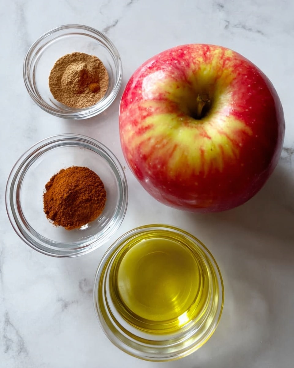 A fresh red and yellow apple sits on a white marbled surface, accompanied by three small clear glass bowls arranged nearby; one bowl contains light brown cinnamon powder, another holds a golden brown liquid, and the third is filled with a light yellow oil, all positioned neatly around the apple. photo taken with an iphone --ar 4:5 --v 7