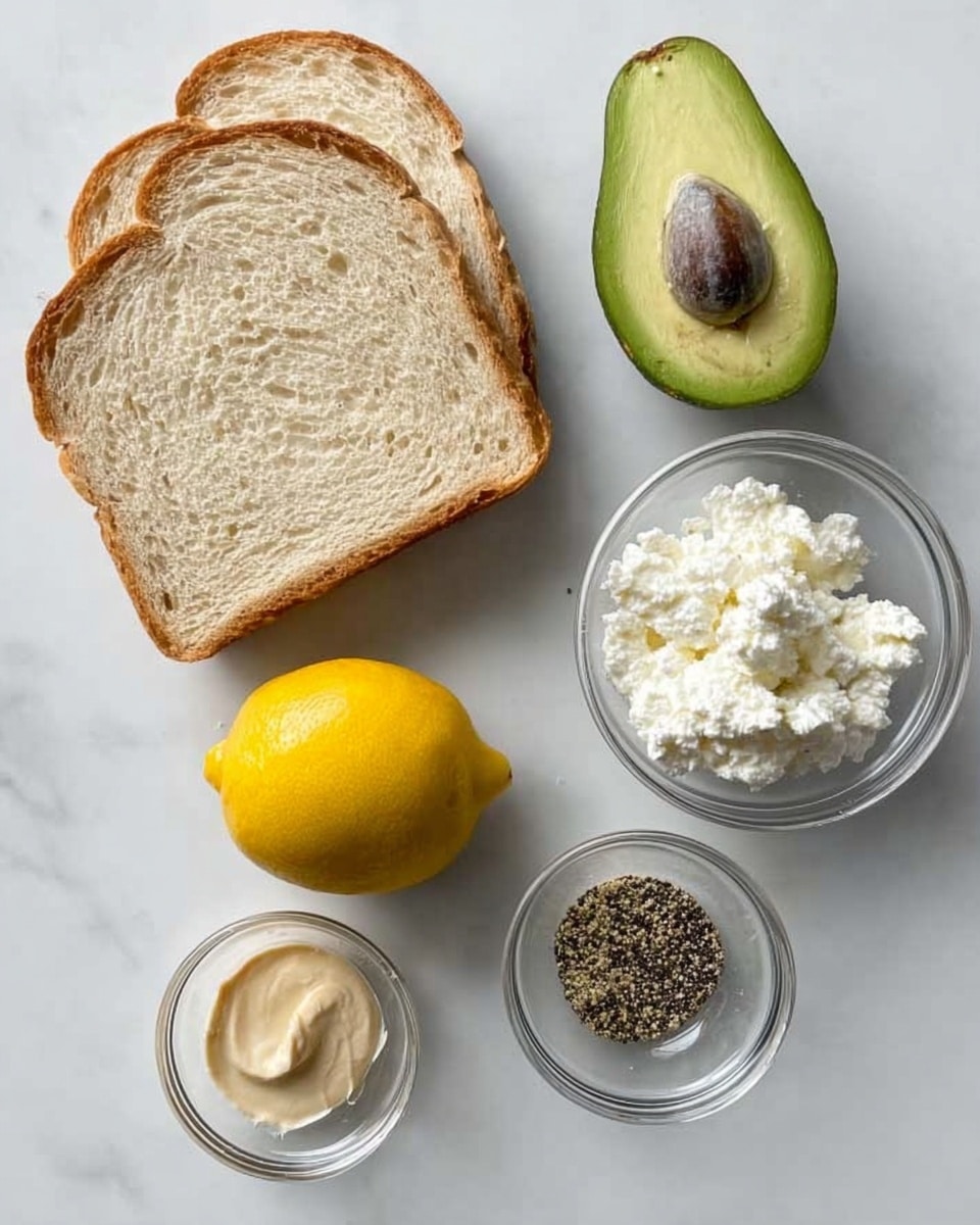 The image shows two slices of light brown bread placed side by side on a white marbled surface. Above the bread, a halved avocado with its bright green flesh and brown seed is positioned. To the right of the avocado, there is a small clear bowl filled with white cottage cheese. Below the avocado and cottage cheese, a whole yellow lemon sits in the center. At the bottom left, a small clear bowl contains a light brown paste, and next to it on the right is another small clear bowl filled with a mix of black and white pepper. Photo taken with an iphone --ar 4:5 --v 7