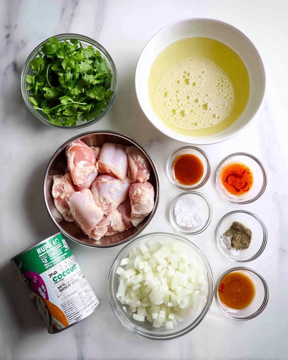 The image shows a white marbled surface with various cooking ingredients arranged neatly. At the center bottom is a silver bowl holding several raw pink chicken pieces. To its right, there is a white bowl filled with chopped white onions. Above the onions, a larger white bowl contains a pale yellow liquid with some bubbles on top. To the upper right of the chicken, small clear glass bowls hold reddish-orange sauce, light yellow liquid, black pepper, brown sugar, and minced garlic from left to right. On the left side, a clear bowl is filled with fresh green cilantro leaves. A small clear bowl with white granulated salt is near the cilantro, and in the bottom left corner, a can of coconut milk with green and purple details is placed. Photo taken with an iphone --ar 4:5 --v 7