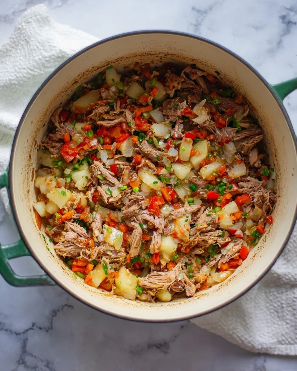 Inside a large round white pot with green handles, there is a mixture of shredded brown meat with soft textures, layered with small white pieces of cooked potatoes, and bright red diced bell peppers. Scattered throughout are translucent white onion chunks and small bits of green herbs, creating a colorful blend. The pot sits on a white marbled surface with a glimpse of a white cloth underneath. Photo taken with an iphone --ar 4:5 --v 7