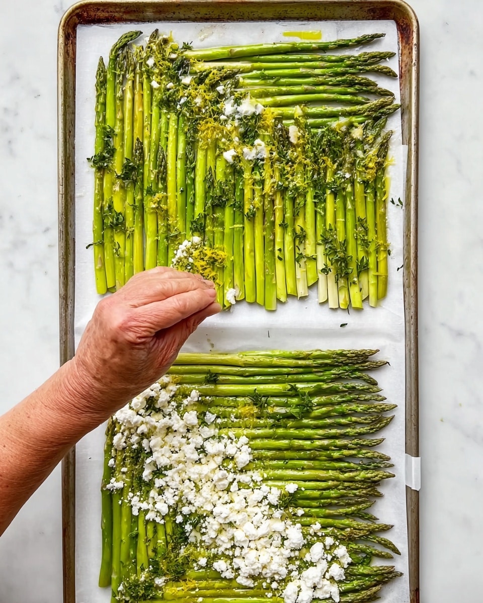 The image shows two square shapes of asparagus arranged neatly in a herringbone pattern on a white marbled surface and on a baking tray. The asparagus pieces are bright green with their tips pointing mostly upward or sideways, creating a textured and orderly design. The top square has a woman's hand adding small bits of fresh thyme and lemon zest over a drizzle of oil next to the asparagus. The bottom square is laid out on a white tray and topped with white crumbles of cheese evenly spread across the asparagus. The scene has a clean, fresh, and organized look with natural green tones against the white background. Photo taken with an iphone --ar 4:5 --v 7