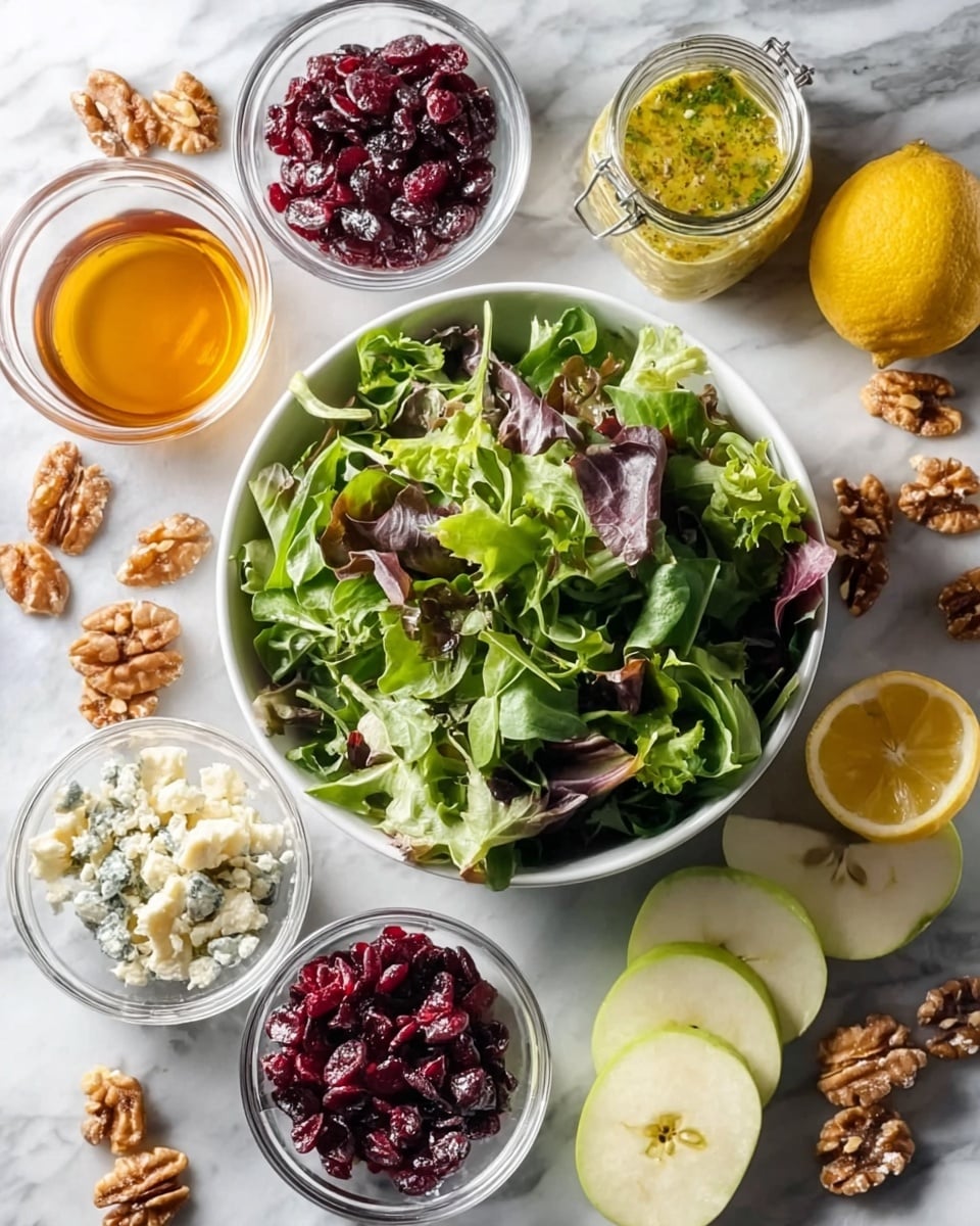 The image shows a white bowl filled with fresh mixed green leaves and some purple leaves inside, placed on a white marbled surface. Around the bowl, there are several small clear glass bowls containing red dried cranberries, pale chopped nuts, crumbled blue cheese, and golden honey. On the white marbled surface, there are also scattered brown walnut halves and green apple slices arranged near a halved green apple. Two lemon halves and a small glass jar with a yellow dressing including herbs are positioned near the top right corner. The colors are vibrant and natural with a fresh and healthy look. photo taken with an iphone --ar 4:5 --v 7