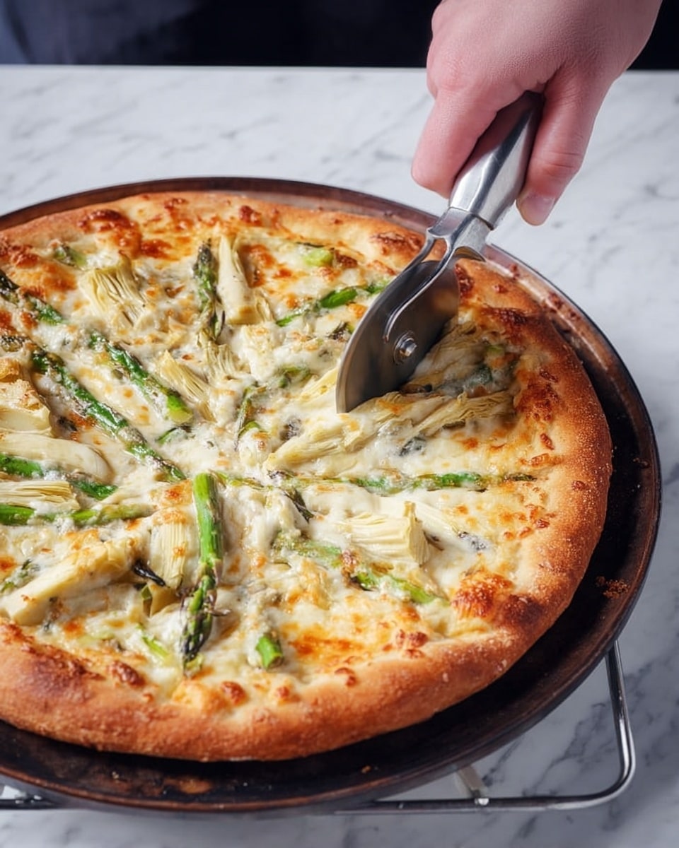 A large pizza with a golden-brown thick crust sits on a dark round pan resting on a metal rack, placed on a white marbled surface. The pizza has a creamy white cheese layer with melted spots of light golden brown spread evenly over the whole surface. Scattered on top are chunks of pale artichoke and long, thin green asparagus pieces, creating a mix of creamy and fresh green colors. A woman's hand holding a shiny pizza cutter is slicing through the pizza near the center, adding an action detail to the scene. photo taken with an iphone --ar 4:5 --v 7