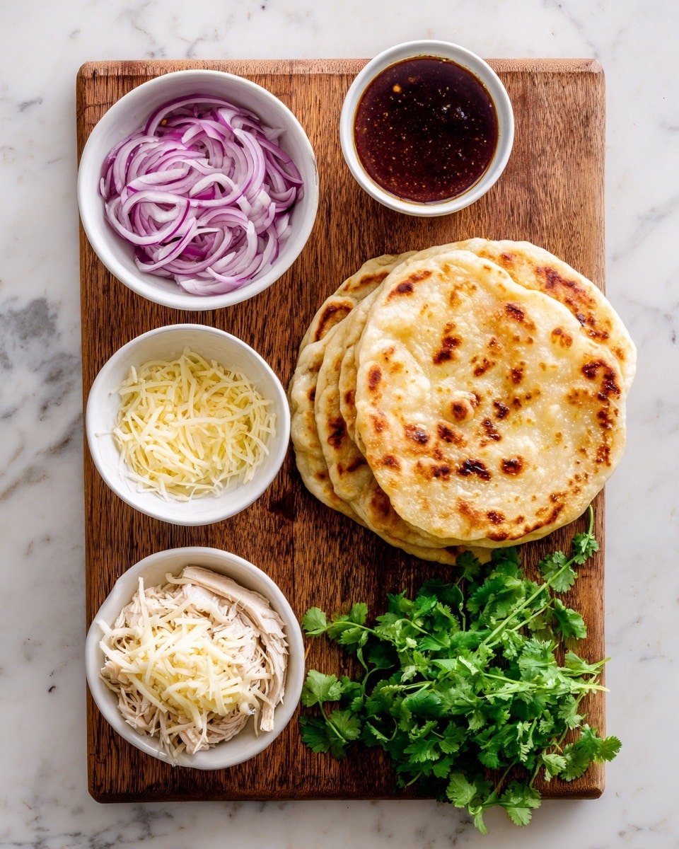 The image shows a wooden board on a white marbled surface, holding five elements: a stack of three light golden brown flatbreads on the right, a small white bowl of thinly sliced purple and white onions at the top left, a small white bowl of dark reddish-brown sauce in the center top, a small white bowl of shredded pale yellow cheese at the bottom left, and a small white bowl of shredded light beige cooked chicken in the center bottom. To the right of the bowls, there is a bunch of fresh green cilantro with visible leaves and stems. The photo taken with an iphone --ar 4:5 --v 7