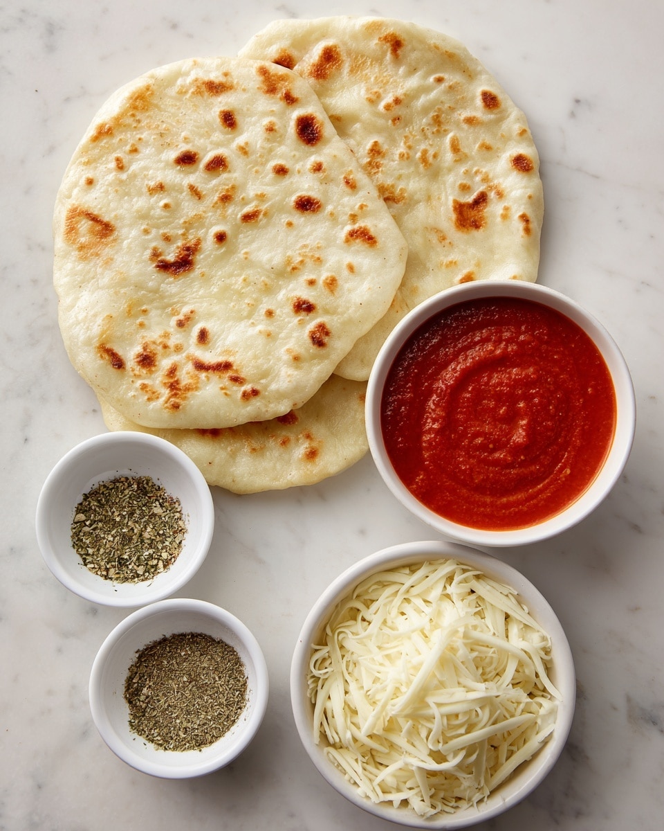 The image shows two pieces of light beige naan bread with golden brown spots stacked on the left side. To the right, there is a small white bowl filled with bright red tomato sauce, smooth in texture. Below the sauce bowl, a white bowl holds shredded mozzarella cheese, which is off-white and soft-looking. On the bottom left, there is a small white bowl divided into three sections containing dried basil, garlic powder, and dried oregano, with colors ranging from green to beige to darker green. All items are arranged on a white marbled surface. Photo taken with an iphone --ar 4:5 --v 7