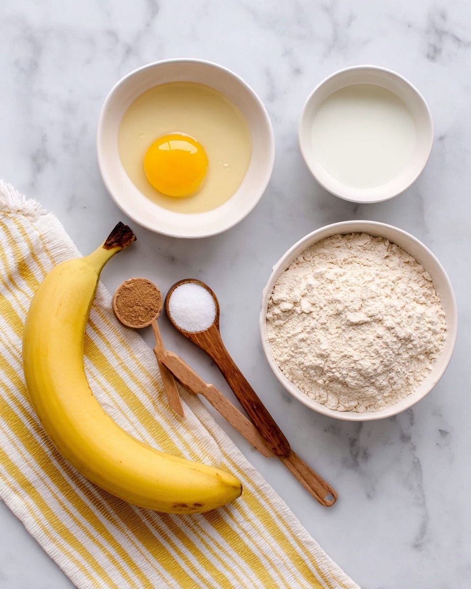 The image shows ingredients arranged on a white marbled surface with a yellow and white striped cloth at the bottom. There is one whole yellow banana laying diagonally near the bottom left. At the top center, there is a white bowl with a raw egg inside, showing a bright yellow yolk and clear egg white. To the right of the egg, there is another white bowl filled with a white liquid. Below these, near the bottom right, there is a white bowl filled with beige flour. On the left side, there are two measuring spoons with wooden handles; one holds a white powder while the other one holds a brown powder. Photo taken with an iphone --ar 4:5 --v 7