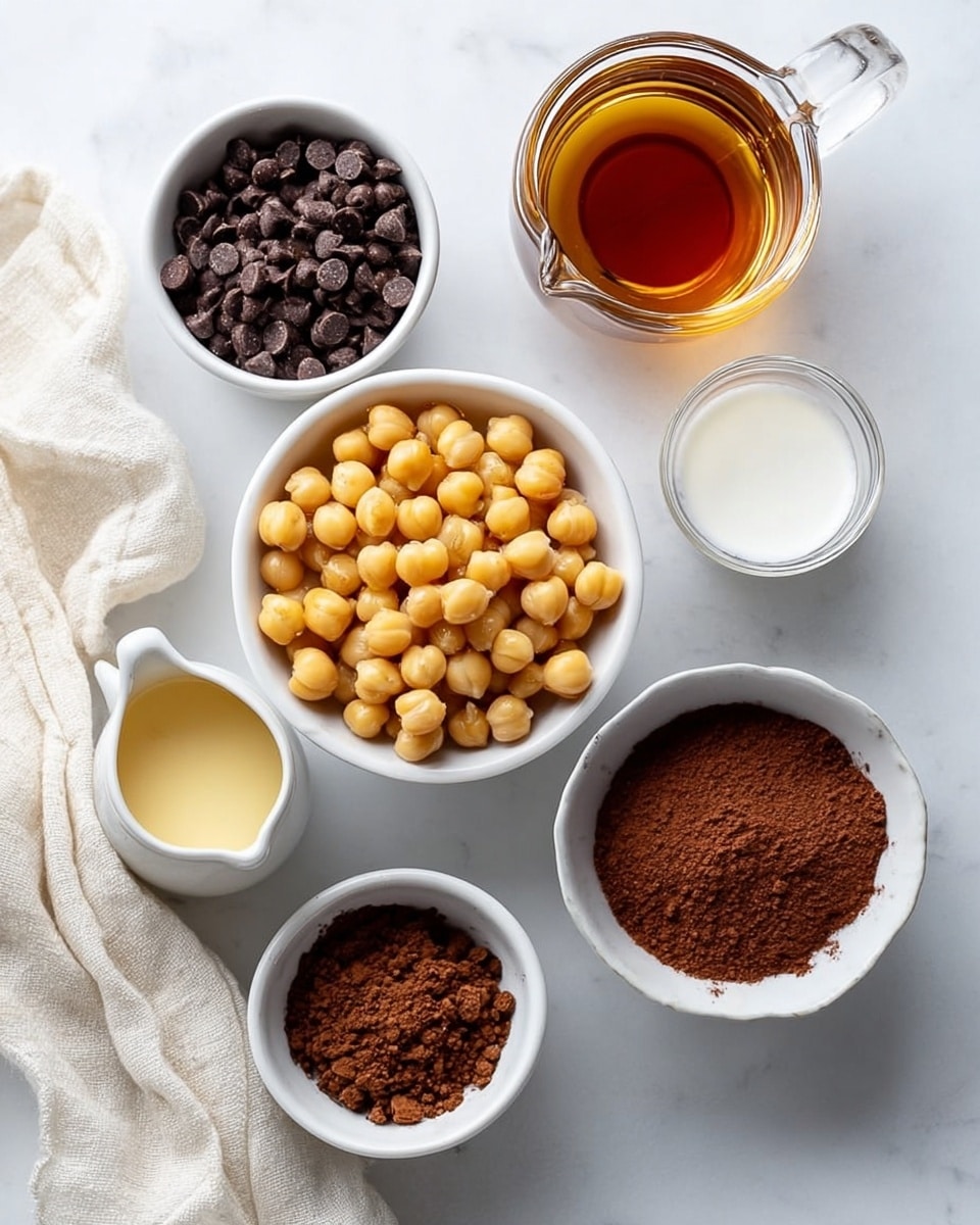 The image shows seven small white bowls and a small white pitcher placed on a white marbled surface. In the center, a white bowl holds light golden chickpeas. Surrounding it, from top center clockwise, there is a bowl filled with small dark brown chocolate chips, a clear pitcher with amber maple syrup, a clear small bowl with white liquid, a white bowl containing a creamy tan liquid, a white bowl filled with dark brown cocoa powder, and a white bowl with light golden honey. A light cream-colored cloth is partially visible to the left side of the scene. photo taken with an iphone --ar 4:5 --v 7