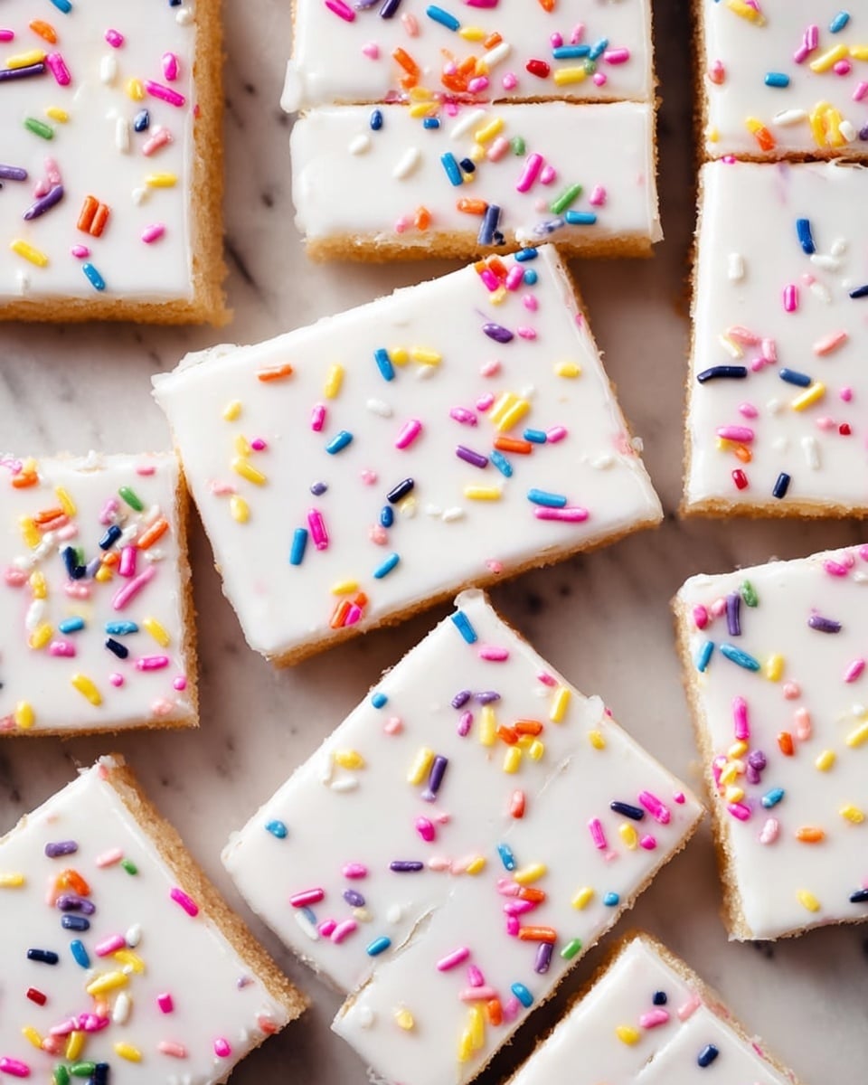 This image shows a close-up of a flat baked dessert cut into 12 rectangular pieces. Each piece has two layers: a light brown base layer with a soft texture, and a smooth, thick white icing layer on top. The white icing is decorated with small, colorful sprinkles in various shapes and colors including red, blue, yellow, pink, purple, orange, and white, scattered evenly across the surface. The dessert is placed on a white marbled surface. photo taken with an iphone --ar 4:5 --v 7