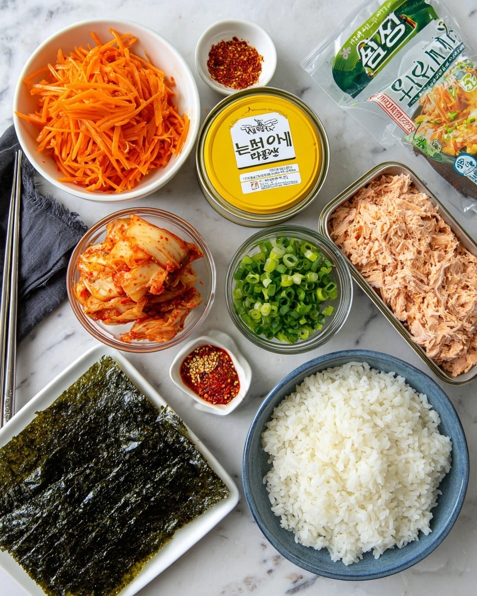 The image shows several small white bowls and containers arranged on a white marbled surface. One bowl is filled with thin, bright orange carrot strips. Another bowl contains finely chopped green spring onions. There is a clear glass bowl with red and light orange kimchi pieces. A blue bowl holds a large serving of white cooked rice. An open can reveals light pink tuna soaked in oil with some red bits. Beside it is a yellow tin lid with Korean writing. A rectangular stack of dark green roasted seaweed sheets rests next to the rice. Two small white dishes hold red chili flakes and creamy mayonnaise. A package of roasted and seasoned seaweed with green and white labeling completes the scene. Two silver metal chopsticks and a black cloth napkin are partly visible on the left side. Photo taken with an iphone --ar 4:5 --v 7