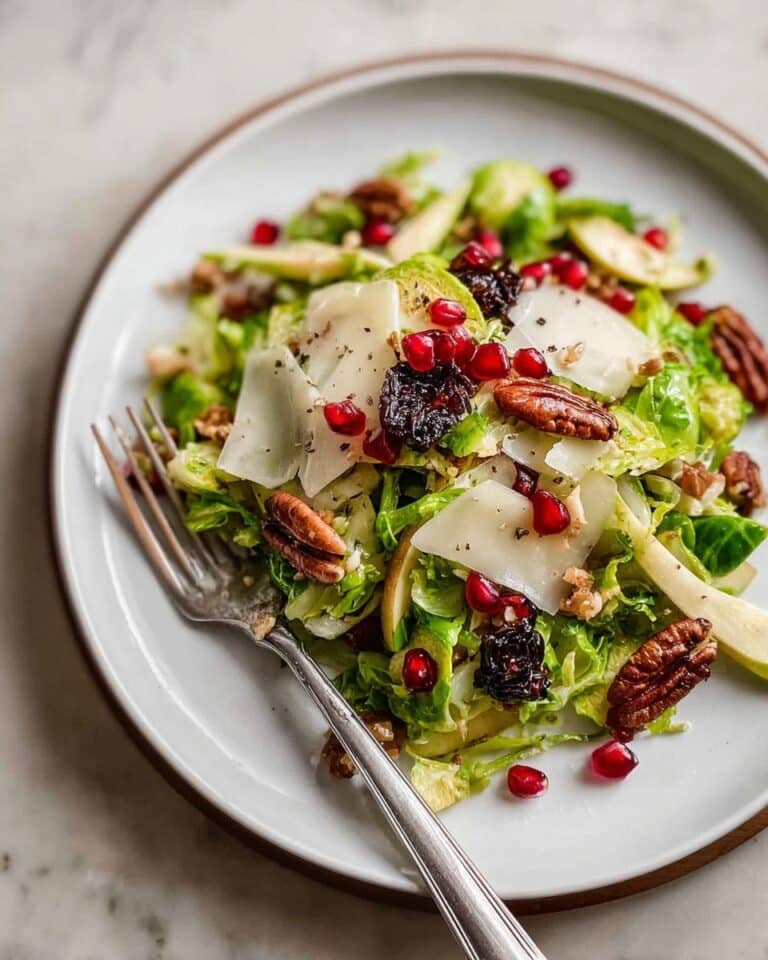 Shaved Brussels Sprout Salad with Honeycrisp Apple, Dried Cherries, Pomegranate, and Lemon Vinaigrette Recipe