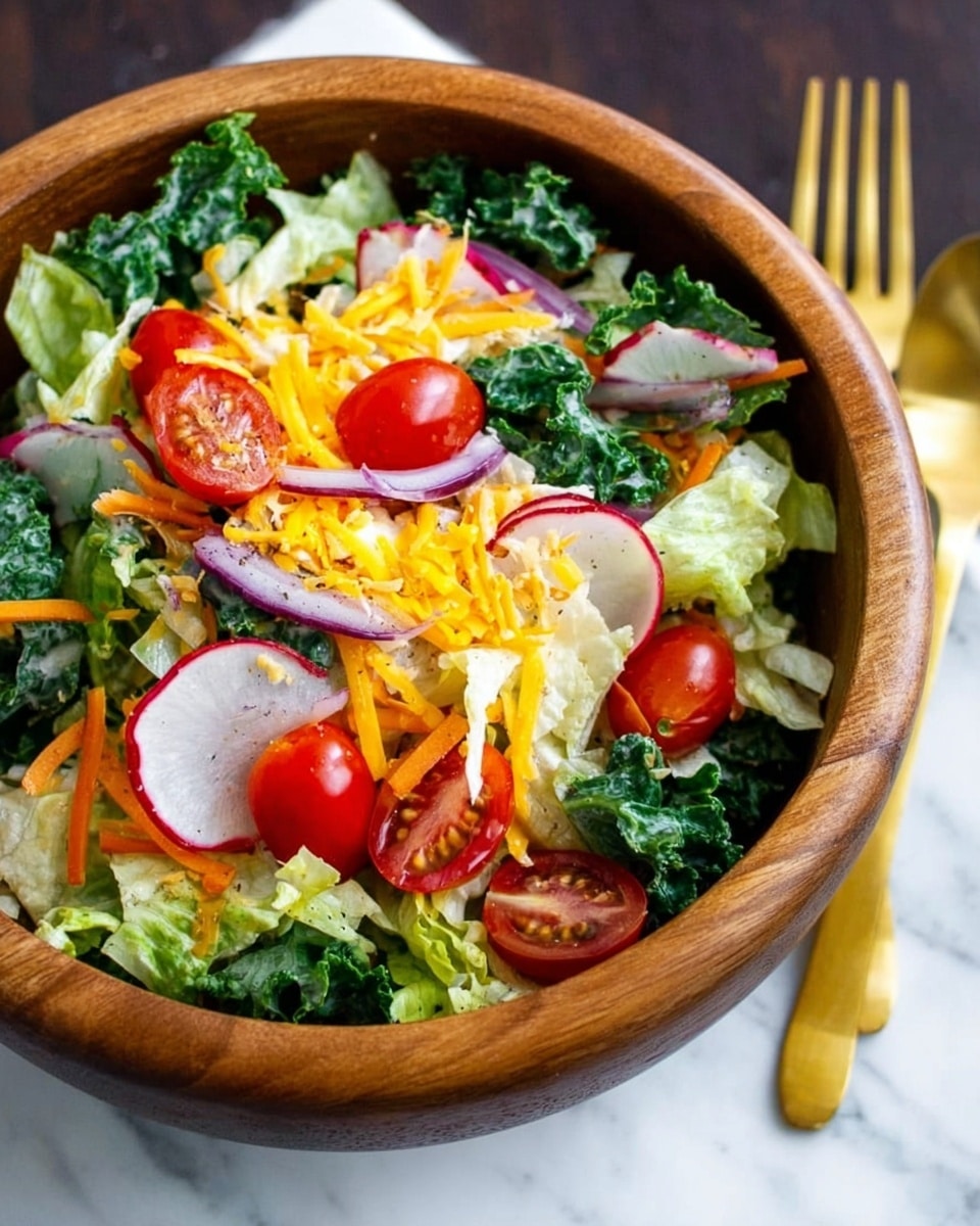 A wooden bowl filled with a fresh salad sits on a white marbled surface. The salad has a base layer of light green lettuce leaves, topped with dark green kale strips. Scattered on top are bright red cherry tomatoes, thin slices of white radish with a red edge, and thin strips of orange carrot. There are also a few thin purple onion slices and shredded yellow and white cheese sprinkled over everything. Two gold forks rest beside the bowl. Photo taken with an iphone --ar 4:5 --v 7