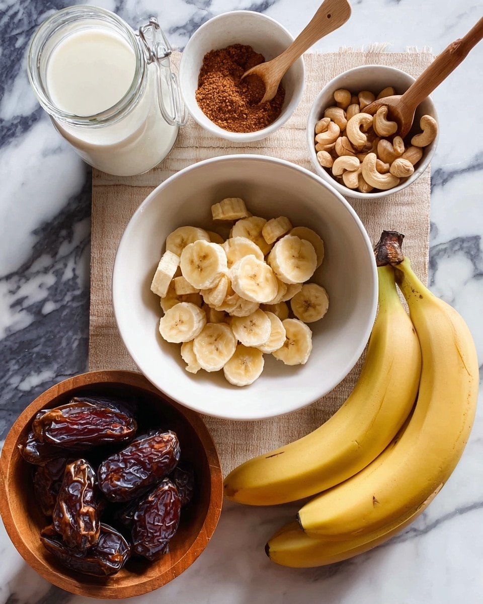 The image shows a white bowl in the center filled with two layers of sliced bananas, light yellow with soft texture, arranged evenly inside the bowl. To the right of the bowl, there are two whole bananas with bright yellow skin and slight brown spots, laying on a white marbled surface. Below the bowl, there is a white bowl holding five dark brown, glossy dates with a smooth texture. To the left, a wooden bowl is filled with a layer of light brown cashew nuts with a rough texture. Above the wooden bowl, there is a small white bowl containing a swirl of brown cinnamon powder. Above the white bowl of bananas, a white mortar with a wooden spoon filled with brown cinnamon powder sits on the white marbled surface. A clear glass jar filled with white milk sits near the top left corner. The whole scene is on a white marbled surface. photo taken with an iphone --ar 4:5 --v 7