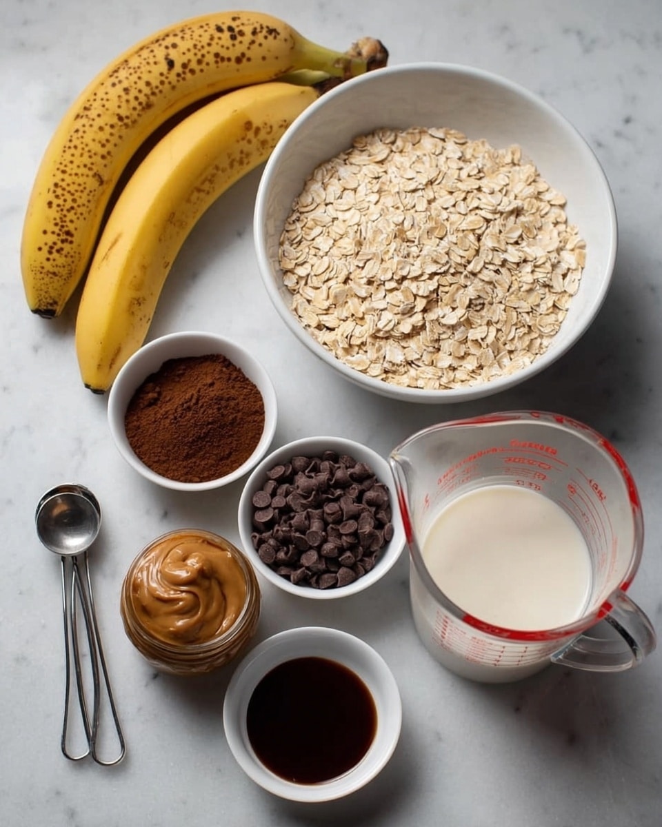 The image shows several ingredients arranged on a white marbled surface, ready to make a dish. There is a bunch of ripe bananas with brown spots at the top left. In the center, a white bowl is full of light beige rolled oats. To the right, a clear glass measuring cup holds white milk with red measurement markings. Below the oats, there are three small white bowls: one with dark brown cocoa powder in the middle, one with shiny dark brown chocolate chips to the right, and another with dark liquid, possibly vanilla or syrup, below the chocolate chips. To the left of the cocoa powder bowl, a small jar of smooth brown peanut butter is visible. Two metal measuring spoons, a tablespoon and a teaspoon, both empty, lie near the bottom left of the image. The whole setup is on a white marbled surface giving a clean and simple look photo taken with an iphone --ar 4:5 --v 7