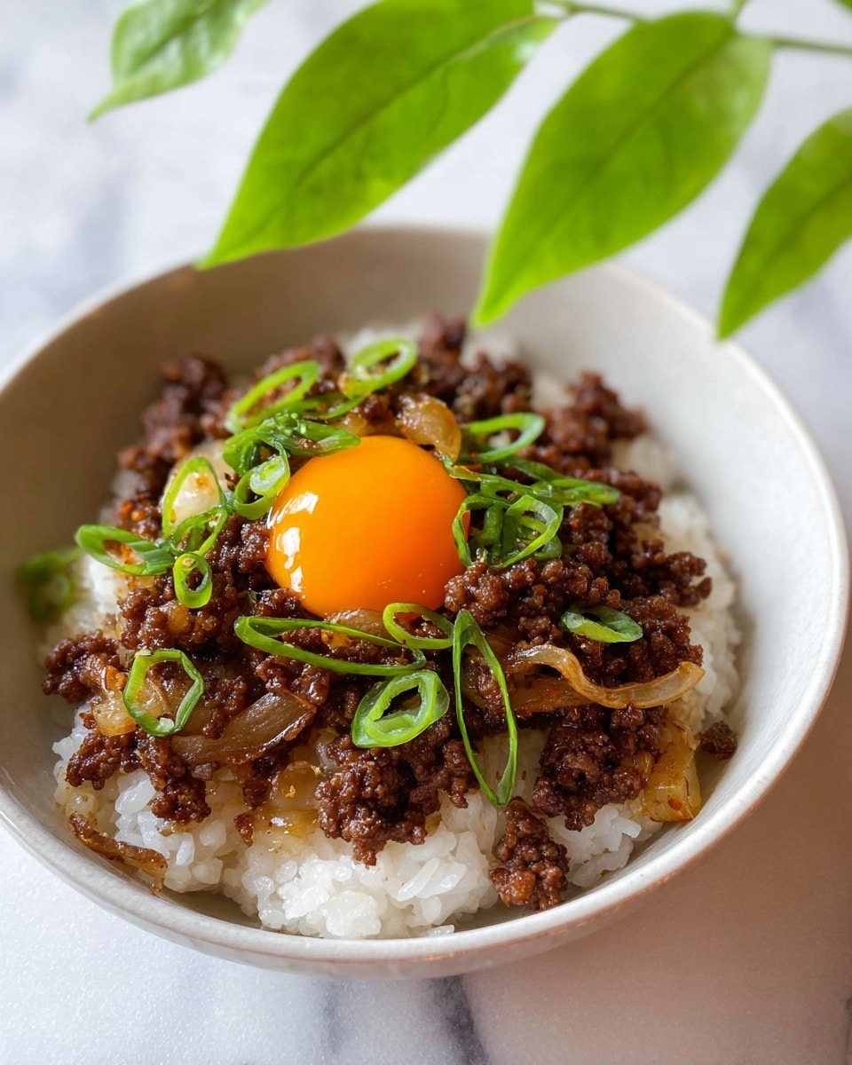 A white bowl holds a layer of soft white rice at the bottom, topped with a thick layer of dark brown cooked ground meat mixed with translucent, slightly browned onion pieces. On top of the meat, there is a bright orange egg yolk, shining and smooth, with thin slices of fresh green onion scattered around it. The bowl sits on a white marbled surface, and green leaves are softly blurred in the background. photo taken with an iphone --ar 4:5 --v 7