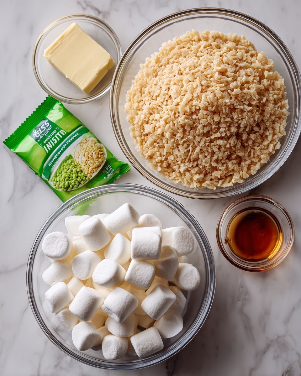 The image shows three clear glass bowls and three small ingredients on a white marbled surface. The largest bowl at the top right is filled with light brown Rice Krispie cereal, showing a crunchy texture. Below and to the left is a medium-sized bowl full of white marshmallows with a smooth, puffy look. To the far left is a glass bowl containing a green packet of pistachio instant pudding mix labeled JELL-O. Below the bowls on the surface are a stick of pale yellow butter, a small clear bowl with amber-colored vanilla, and the green pudding packet. The items are neatly arranged, ready for making a dessert. photo taken with an iphone --ar 4:5 --v 7